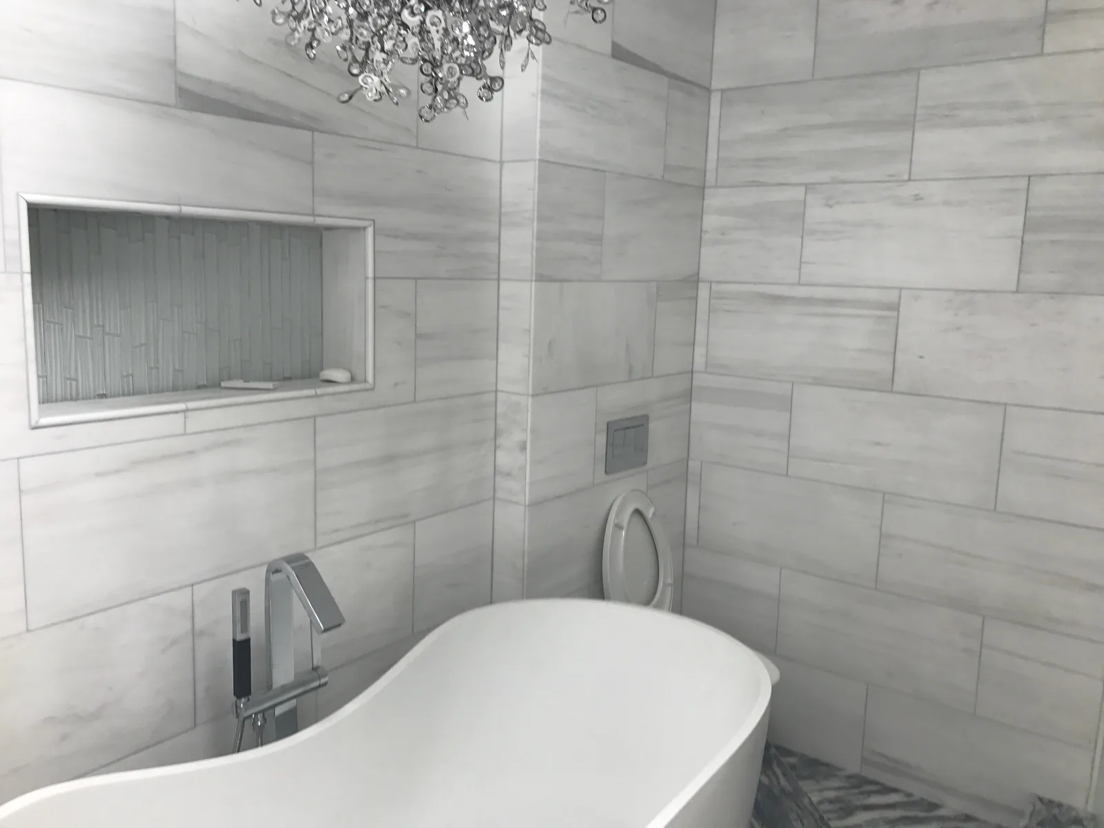 Bathroom hottub and shower tiles with visible niche